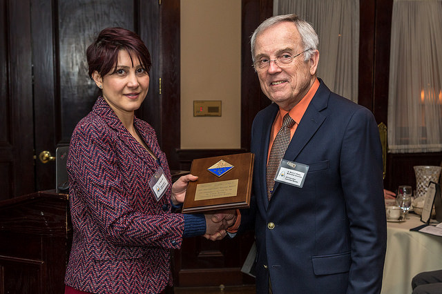 Pegah Jalili presents the 2015 Distinguished Service Award to Dr. Myron C. Reese.