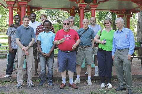 This is almost all the people who were still there when someone shouted, “Group photo!” For some reason, all of Jeff’s summer students adsorbed to Eric Bruton: from the left, they are Kevoh (Calvin) Nyapete (Kenya), (Eric), Godfred Fianu (Ghana), Garrett Fielding (USA), and Brian Kamusinga (Kenya). Everyone else in the photo appreciated their help and good cheer. Behind the camera: photographer Vic Lewchenko.