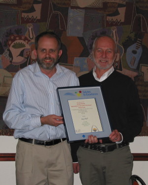 Greg Wall shows off his plaque and his smile as Jeff Cornelius presents the Salute to Excellence.
