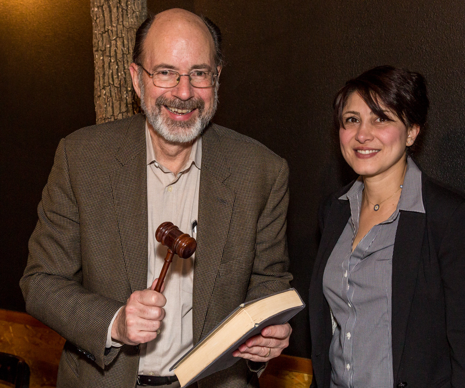 Joe Ackerman receives book and gavel, the trappings of the Chair, from Pegah Jalili