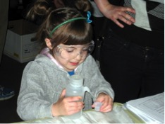 Mirah Brengard experiments with filling a cup with a water bottle for the Enzymes experiment at the Kids and Chemistry at the Saint Louis Science Center for Chemists Celebrate Earth Day on 4/20/13.