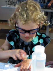 Emma Landsness experiments with mixing for the Enzymes experiment at the Kids and Chemistry at the Saint Louis Science Center for Chemists Celebrate Earth Day on 4/26/14.