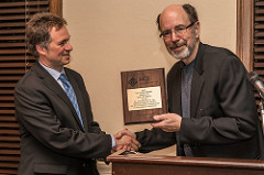 Dr. Ackerman presenting award to Dr. Mirica